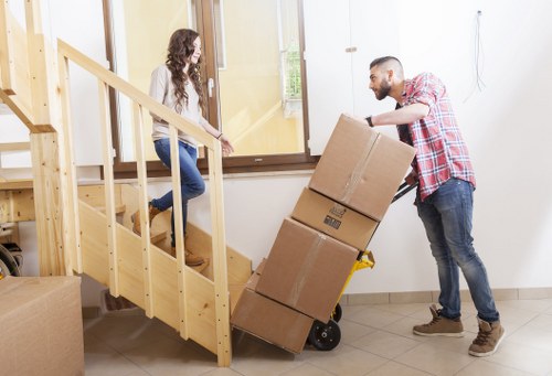 Packed boxes, books, and small furniture prepared for student storage
